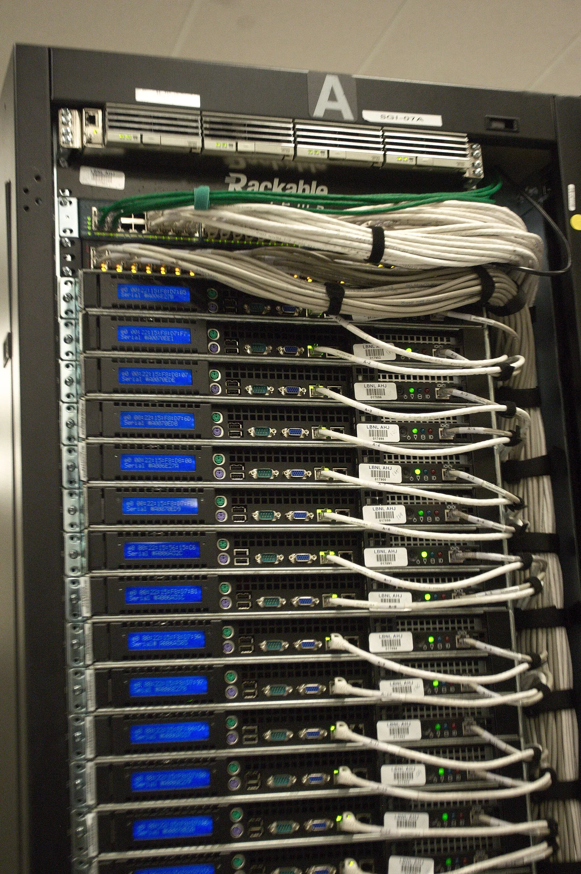 Cables and servers at the back of a data center rack